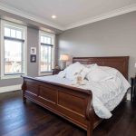 large sleigh bed in master bedroom of luxury home